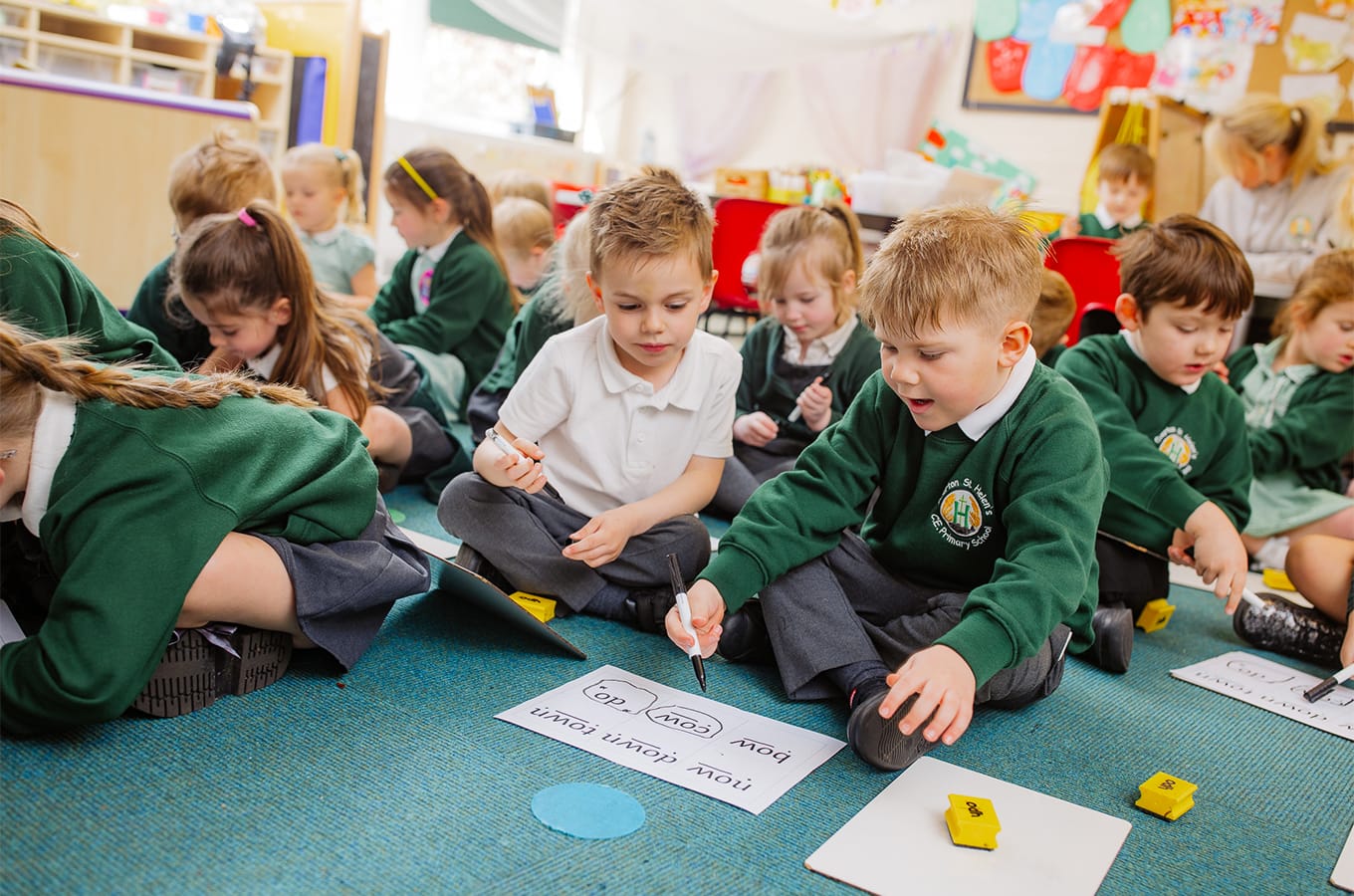 children crosslegged in classroom